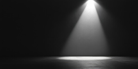 Spotlight on an empty stage creates an atmosphere of anticipation and possibility in a dimly lit room