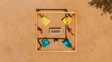 Aerial top view of wood pergola, hammock swings, chairs, firepit