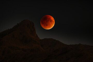 Bloody Red moon, lunar eclipse over the mountain.