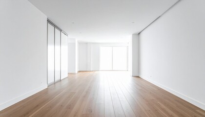 Empty, modern interior with hardwood flooring, white walls, and large windows, bathed in natural light.