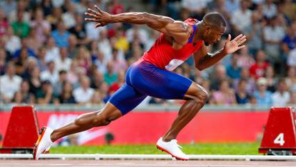 Naklejka premium Male Sprinter Starting a Race from the Blocks