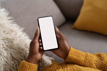 a black woman using a smartphone with a blank screen, sitting on a sofa at home and looking down at the mobile phone in her hand Generative AI