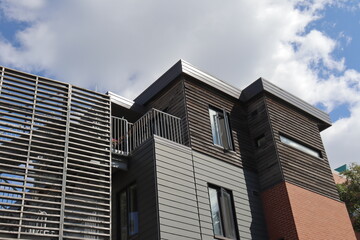 Facade of a modern construction for condos or apartment. Modern architecture and house and residential structure.