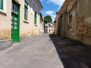 historic buildings on a street in the old town in Galati Romania build before the world war , back alley daytime in the city center