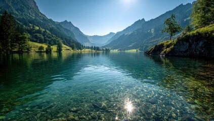 Obraz premium Serene alpine lake reflecting mountains. Crystal-clear water, sunlit, with lush greenery surrounding a tranquil valley