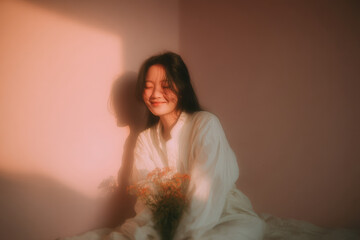 girl joyfully holds beautiful bouquet of flowers against soft pink background radiating warmth and tenderness