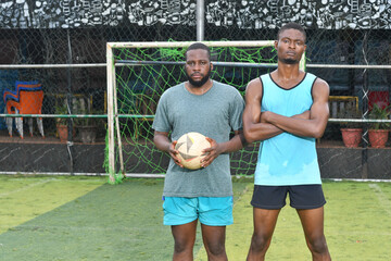 two african Soccer players having fun after friendly match on soccer field