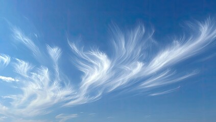 Wispy, flowing clouds against a vibrant blue sky.  Delicate, feathery formations drift across a cerulean backdrop.  Soft, bright white clouds with subtle variations in density, gracefully curving