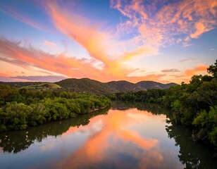 Serene river sunset reflecting vibrant clouds