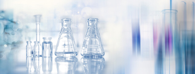 glass flask and vial at biochemistry blue science lab banner background
