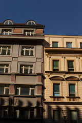 Obraz premium A beautiful row of various buildings set against a clear blue sky in the background, capturing the essence of urban architecture