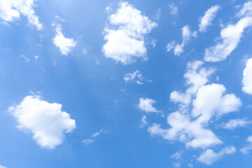 Low angle view and full frame of beautiful blue sky with strange shape of fluffy white clouds in the afternoon on sunny day used as natural background texture in decorative art work