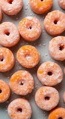 Close-up on sweet orange donuts with sugar icing and eye-catching details