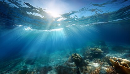 beneath the ocean surface sunlight filters through waves creating a tranquil underwater scene with vibrant hues