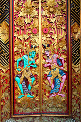 Intricate carvings adorn the door of Pura Ulun Danu Beratan, reflecting traditional Indonesian artistry in Bali, Indonesia.