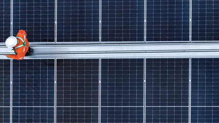 Solar power technician inspecting rooftop solar panels, performing maintenance and installation of renewable energy systems for a sustainable future.
