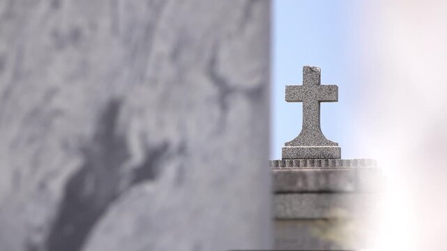 Stone cross headstone at graveyard 4k