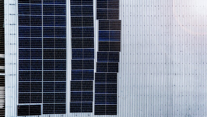 Rooftop solar panel installation set against a backdrop of lush green mountains, showcasing clean energy solutions in harmony with natural landscapes.