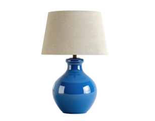 A  light beige linen lampshade sits atop a cobalt blue ceramic base
