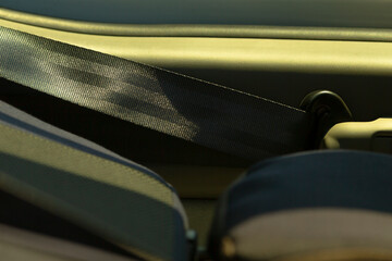 This image showcases a car seatbelt, illustrating both the belt and the buckle within the interior...