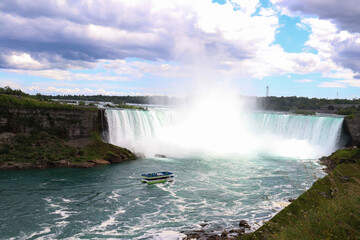 Fototapeta premium Iconic Niagara Falls waterfall viewed from Canada with mist and power.