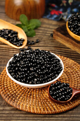 Mixed Black Grain Soybeans and Yellow Hearted Beans in Wooden Bowls on Rustic Kitchen Table
