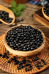 Mixed Black Soybeans and Beans in Wooden Bowls on Natural Wicker Base