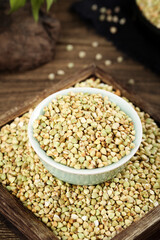 Raw Buckwheat Groats in Bowl on Wooden Surface - Healthy Whole Grain Cereal Ingredient