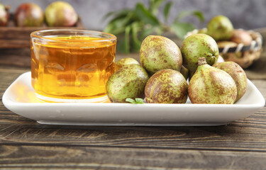 Camellia Oil Seeds and Golden Oil on Wooden Table - Natural Agricultural Harvest and Traditional Extraction