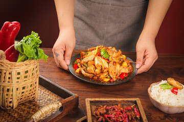 Chef Serving Spicy Stir-Fried Hot Dish with Vegetables on Sizzling Plate - Asian Cuisine Presentation