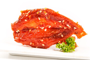 Dried Fish Fillet with Honey Glaze and Sesame Seeds - Asian Seafood Snack on White Plate