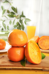 Fresh Persimmons on Wooden Board with Orange Juice - Healthy Fruit Arrangement on White Background