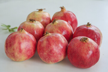 Fresh Red Pomegranates on White Background - Healthy Organic Fruit Rich in Antioxidants