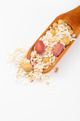 Mixed nuts beans grains spilling from wooden scoop healthy protein ingredients white background