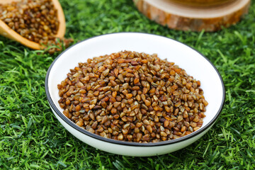 Raw Buckwheat Groats in Bowl on Grass - Healthy Whole Grain Cereal for Organic Diet and Gluten-Free Cooking