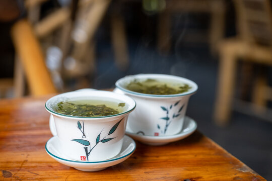Two Cups of Green Tea Served on Wooden Table Outdoors