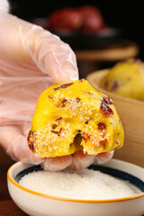 Hand Holding Sweet Date Cranberry Bun with Milk for Breakfast Dipping