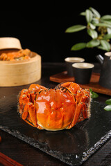 Steamed Hairy Crab Chinese Delicacy on Slate Plate with Traditional Tea Service