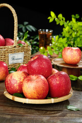 Fresh Frost-Covered Red Apples from Daliangshan in Bamboo Basket with Honey Tea