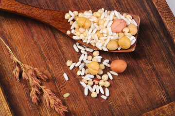 Mixed grains legumes rice wooden spoon rustic farmhouse table healthy protein ingredients