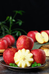 Fresh Red Apples with Star Cut Slice and Mint Garnish on Rustic Wooden Table