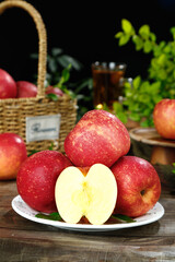 Fresh Red Apples from Yunnan Zhaotong Daliangshan Area with Morning Frost Dewdrops on Rustic Wooden Table
