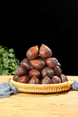 Fresh Salak Snake Fruit from Bali in Wicker Basket - Exotic Tropical Produce Display