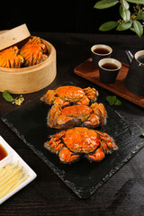 Steamed Hairy Crabs with Tea Traditional Asian Seafood Cuisine on Dark Wooden Table