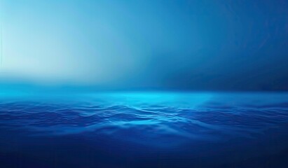 Obraz premium Serene ocean scene at dawn or dusk, featuring a gradient of deep blues, from a lighter sky to darker water with subtle wave textures