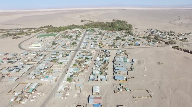 Aerial drone videos of a traditional desert village with colonial church and green oasis in the Atacama Desert, northern Chile