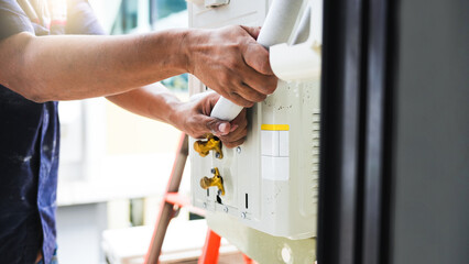 Technician Installing New Air Conditioner Unit, HVAC Specialist Working on an AC System, Professional Repairing Wall-Mounted Air Conditioner
