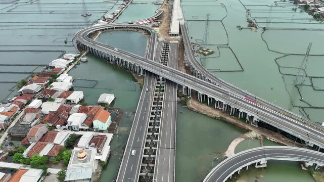 Aerial perspective unveils modern highway system amidst rural landscapes