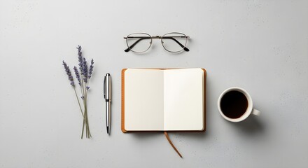 Flat lay of an open notebook with a cup of coffee, glasses, and lavender flowers on a gray background