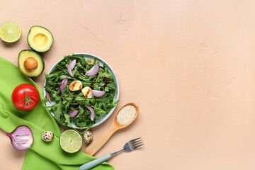 Bowl with tasty arugula salad and ingredients on beige background